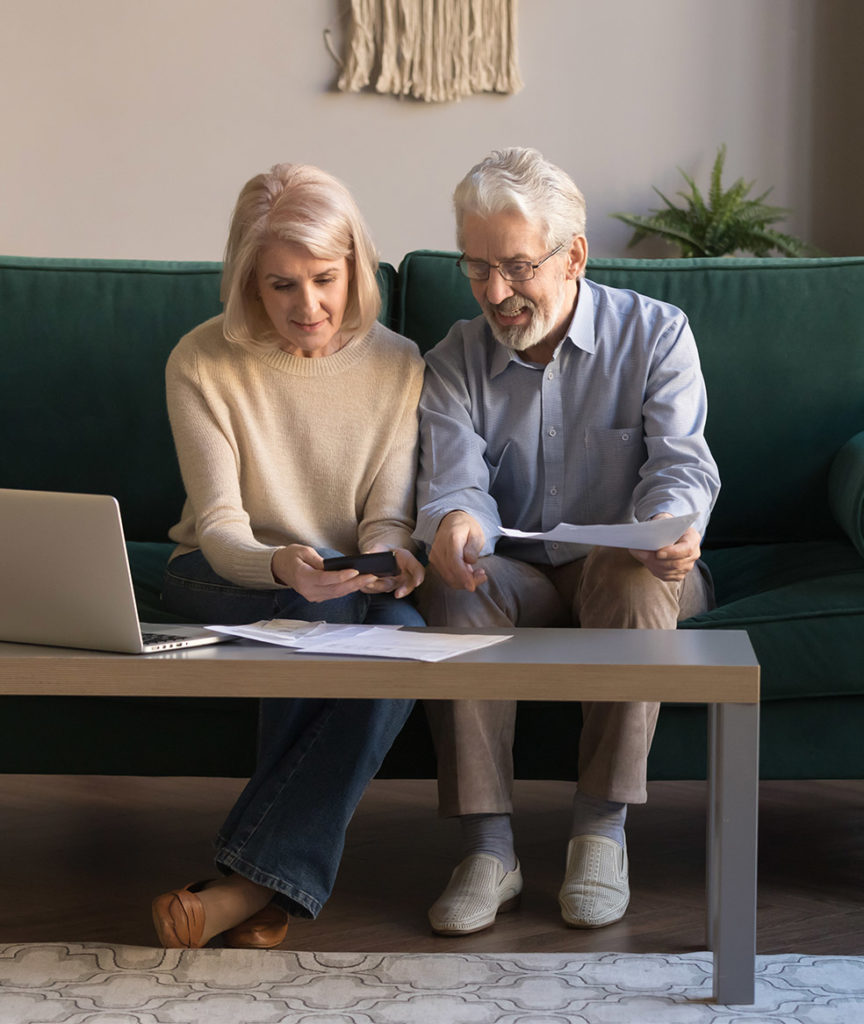 senior couple on couch talking retirement income